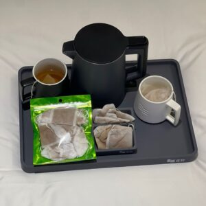 Image of a tray with Fate Flat Tummy Tea, a mug and a kettle.